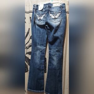 Rise: 9"Inseam: 34" Miss Me Women's Mid Rise Ancien Twing Boot Cut Miss Me Jeans